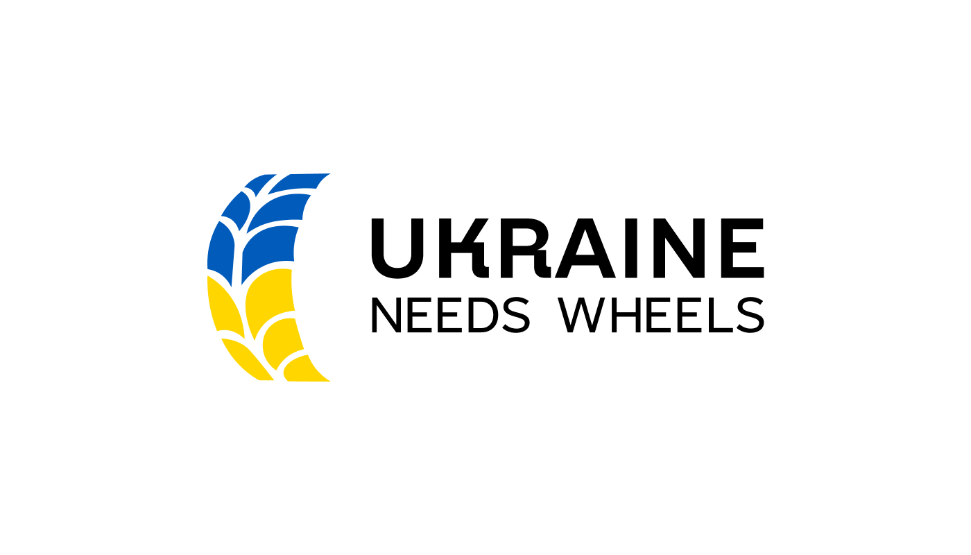Логотип Ukraine Needs Wheels на світлому фоні - розробка логотипу для волонтерів Київ, гуманітарна допомога Україні